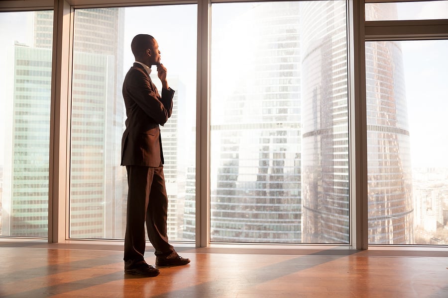 Businessman in profile looking out over the city skyline