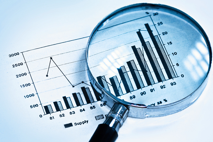 Magnifying glass highlighting a rising bar chart