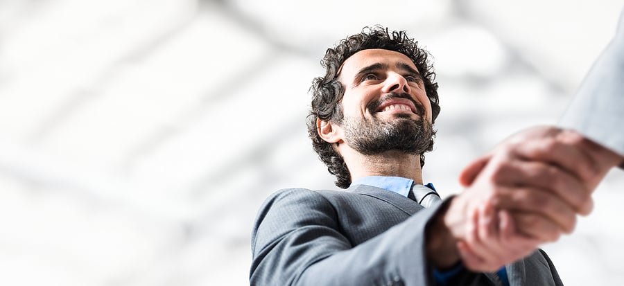 Smiling businessman shaking hands with a colleague
