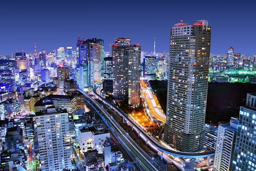 City skyline lit up at night with busy roads below