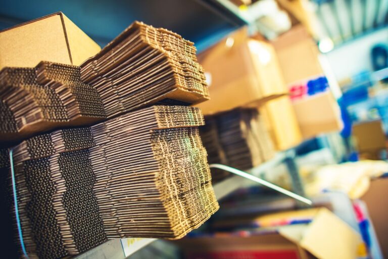 Stacks of flat cardboard boxes ready for packaging in a logistics operation