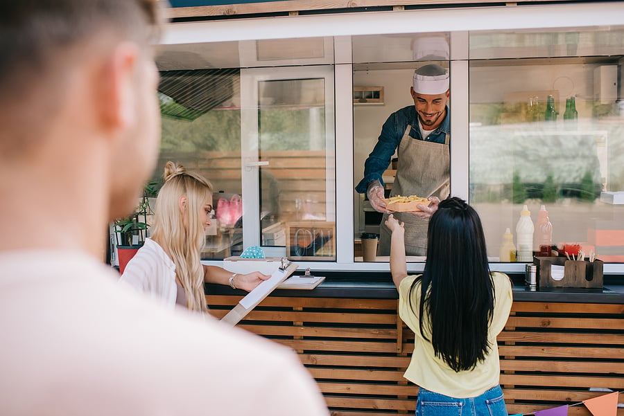 Customer being served at a food truck order window