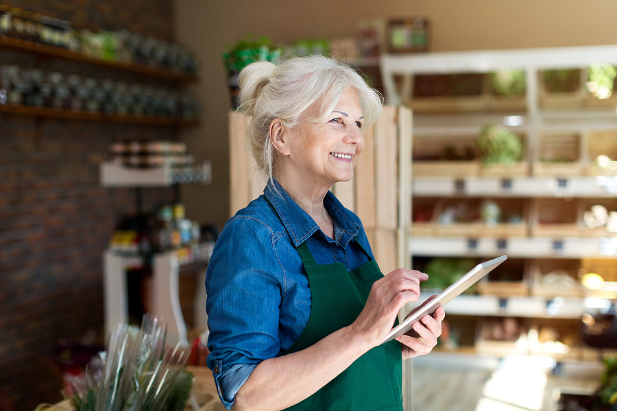 Shop employee holding a digital tablet in a retail store