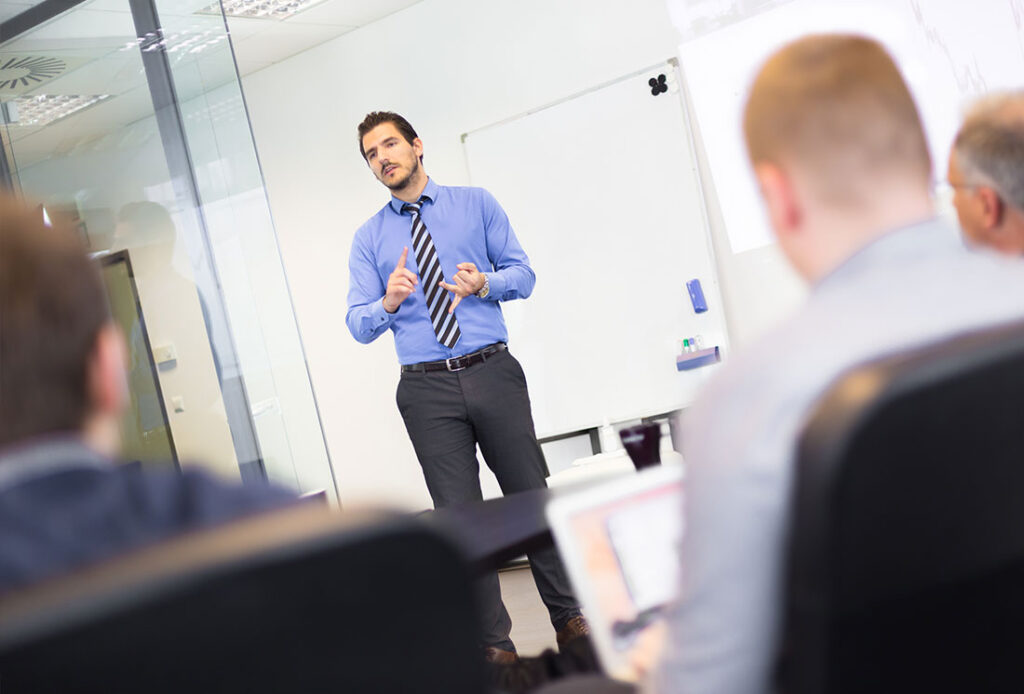 Man presenting to colleagues in a conference room
